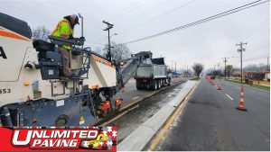 Pavement being milled and dumped into a dump truck